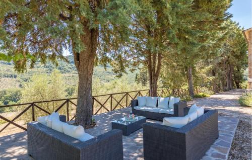 a patio with two chairs and a table and trees at Cozy Home In Orvieto With Wifi in Orvieto