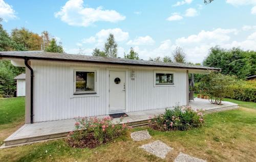 a small white house with a porch at 2 Bedroom Lovely Home In Höganäs in Höganäs
