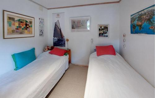 two beds in a room with white walls at 2 Bedroom Lovely Home In Höganäs in Höganäs