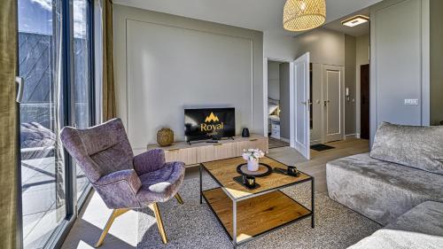a living room with a couch and a fireplace at Źródło Izery przy gondoli VIP Sauna, Siłownia, Bawialnia by Royal Aparts in Świeradów-Zdrój