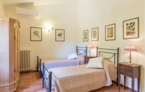 a bedroom with two beds and a table with a lamp at Cozy Home In Orvieto With Wifi in Orvieto