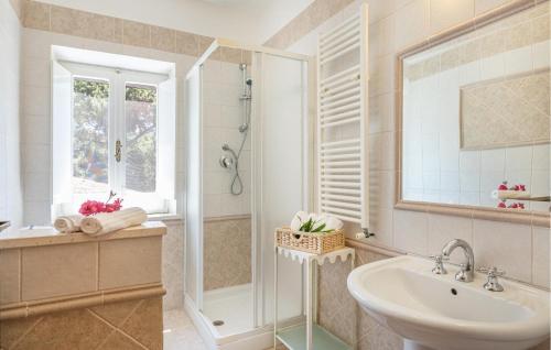 a white bathroom with a sink and a shower at Cozy Home In Orvieto With Wifi in Orvieto