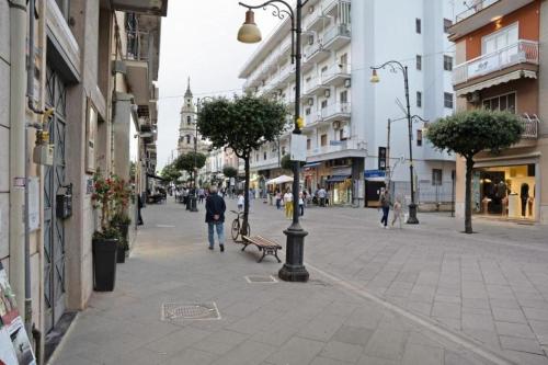 a city street with people walking down the street at Pompei Luxury Suite in Pompei