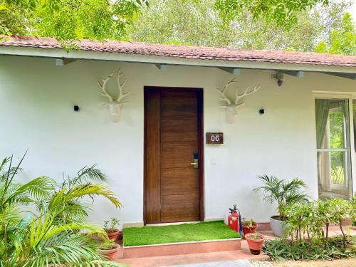 a house with a door with deer heads on it at Karma Lakelands Golf Resort & Residences in Gurgaon