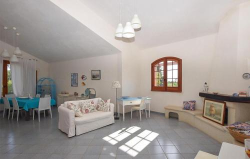 a living room with a couch and a table at Gorgeous Home In Noto in Noto