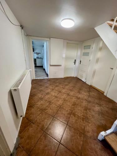 an empty room with white cabinets and a tile floor at Casa de Rainer Copenhagen Room 9 in Copenhagen