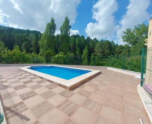 a swimming pool in the middle of a patio at La Guijarroseña , Rio Madera in Segura de la Sierra