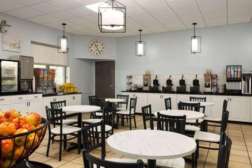 a restaurant with tables and chairs and a counter at Days Inn by Wyndham Hershey in Hershey