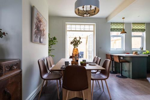 a kitchen and dining room with a table and chairs at Emerald Park - HOT TUB & GAMES ROOM! in Scarborough