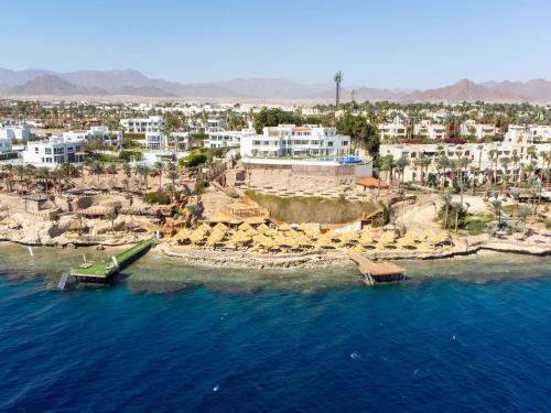 an aerial view of a beach with buildings and the ocean at Pickalbatros Golf Luxury Suites - All Inclusive in Sharm El Sheikh