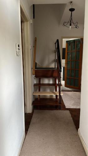 a wooden chair sitting in the corner of a room at Guest House in Rose Meare Gardens in Bristol