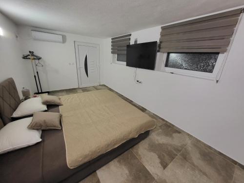 a white room with a bed and a window at Sunset Pool Retreat in Zagrađe