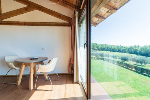 a room with a table and chairs and a large window at Agriturismo Dolce Colle in Volpago del Montello