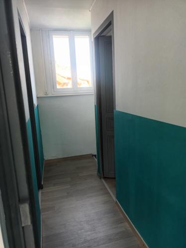 an empty room with a window and a door at Charming Charmes in Charmes