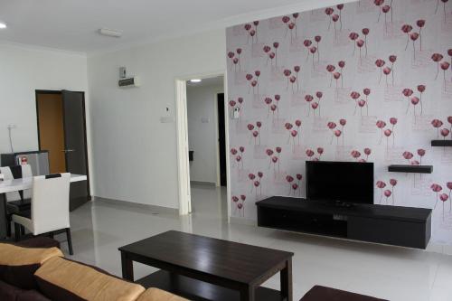 a living room with a couch and a table at Tiara Desaru Seaview Residence in Desaru