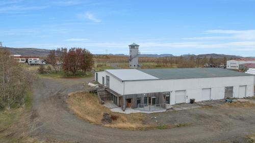 an overhead view of a white building with a clock tower at Klettar - The Old Hatchery Iceland in Fludir