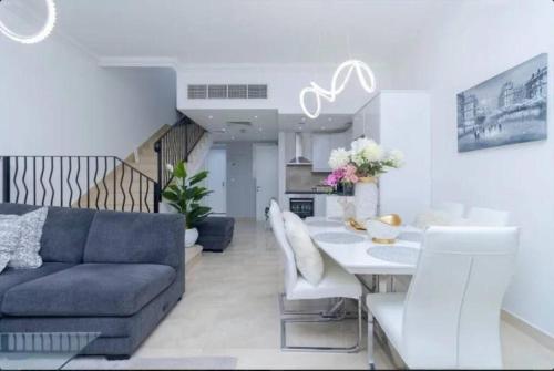 a living room with a couch and a table at Villa in Al Hamra Village in Ras al Khaimah
