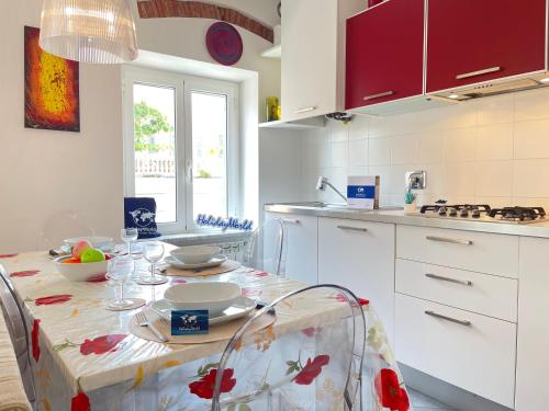 a kitchen with a table with a tablecloth on it at Gaia Home by Holiday Home in Loano