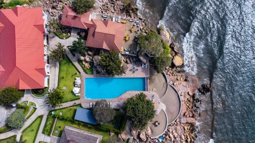 an overhead view of a swimming pool next to the ocean at Sigelege Beach Resort in Senga