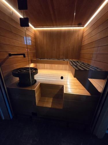a wooden sauna with a pot in the middle at Villa Pare in Rovaniemi