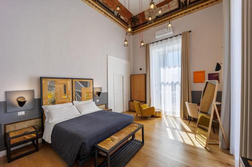 a bedroom with a bed and a desk in it at The Dante House by House In Naples in Naples
