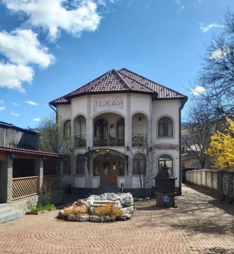 a large white building with a sign on it at Вілла Токай in Rakhiv