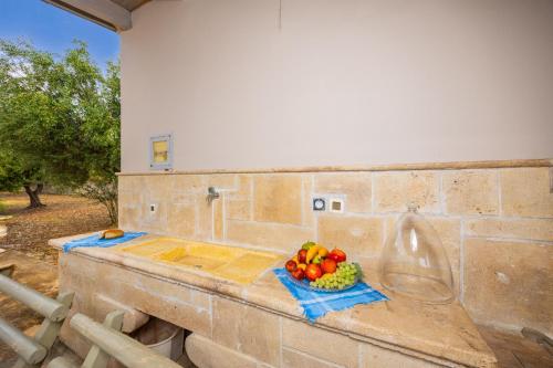 a bowl of fruit sitting on a stone counter at Villa Pomegranate Tree in Katelios