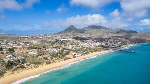 an aerial view of a beach with mountains in the background at Abelisa by An Island Apart in Porto Santo