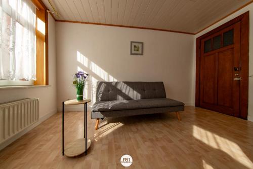 a living room with a couch and a table at Résidence des Chartriers in Mons