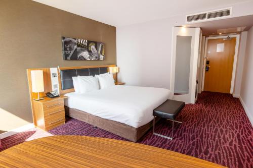 a hotel room with a large bed and a chair at Holiday Inn Manchester-Mediacityuk by IHG in Manchester