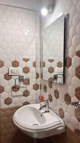 a bathroom with a sink and a mirror at Arize You Homes Anjuna in Anjuna