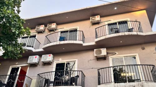 a building with balconies and air conditioners on it at Arize You Homes Anjuna in Anjuna