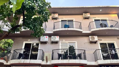 a building with balconies with tables and chairs on it at Arize You Homes Anjuna in Anjuna