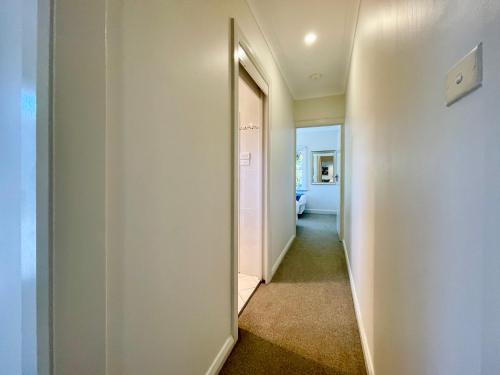 a hallway with a door leading into a room at Scarlett's Place in Blackheath