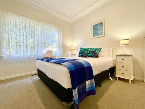 a bedroom with a large bed and a window at Scarlett's Place in Blackheath