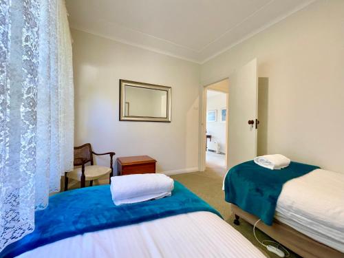 a hotel room with two beds and a mirror at Scarlett's Place in Blackheath