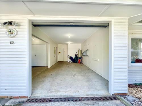 an open garage door of a house with a person at Scarlett's Place in Blackheath