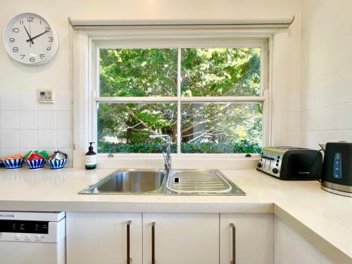 a kitchen counter with a sink and a window at Scarlett's Place in Blackheath