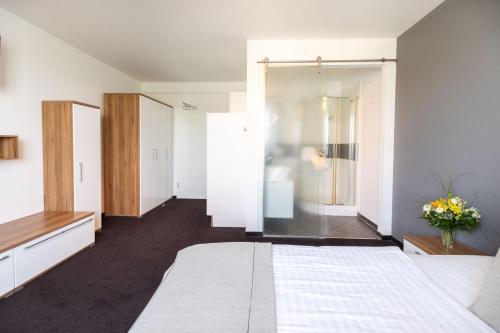 a bedroom with a bed and a sliding glass door at Hotel Aviva in Leipzig