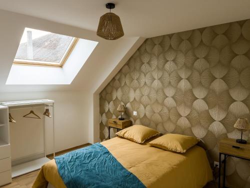 a bedroom with a bed and a skylight at Logement familial cosy proche d'Auxerre & Chablis in Vergigny