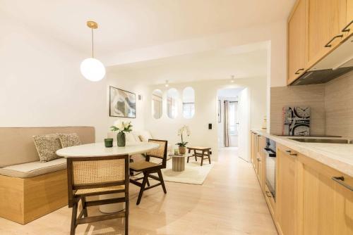 une cuisine et un salon avec une table et des chaises dans l'établissement Opéra - Elégant appartement - Haystia, à Paris