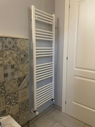 a bathroom with a towel rack next to a door at Villa Maria in Occhieppo Inferiore