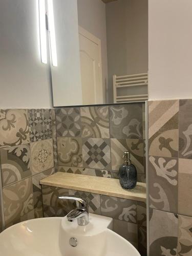 a bathroom with a sink and a mirror at Villa Maria in Occhieppo Inferiore