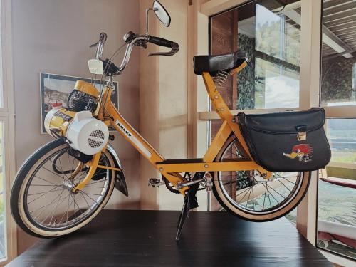 a bike parked on a table in a room at Le Relais de la Croisée in Malvilliers