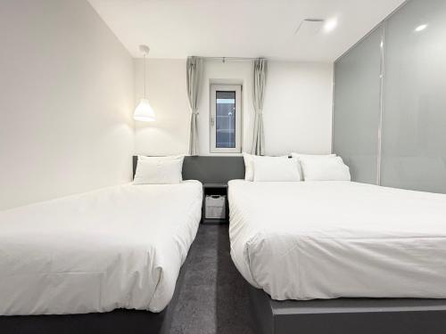 Hotel Firststay Hongdaeにあるベッド