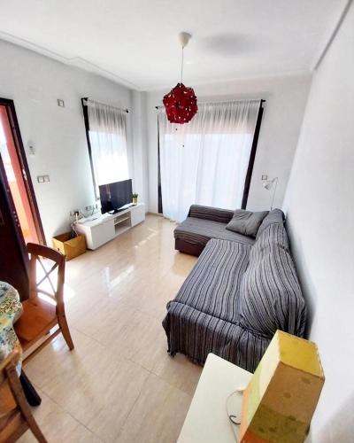 a living room with a bed and a couch at S&H La Consentida in San Juan de los Terreros