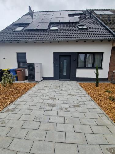 a house with solar panels on the roof at New & Modern Apartment near Düsseldorf in Willich