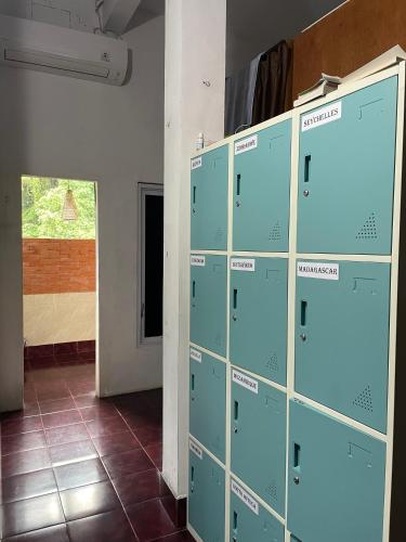 a row of lockers in a room with a door at WW Backpackers in Ubud
