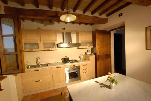a kitchen with a sink and a stove top oven at Ca' Matra in Lama