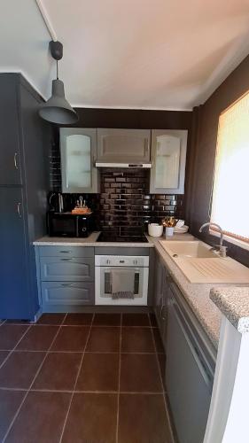 a kitchen with a stove and a counter top at Le Parc in Sarcelles